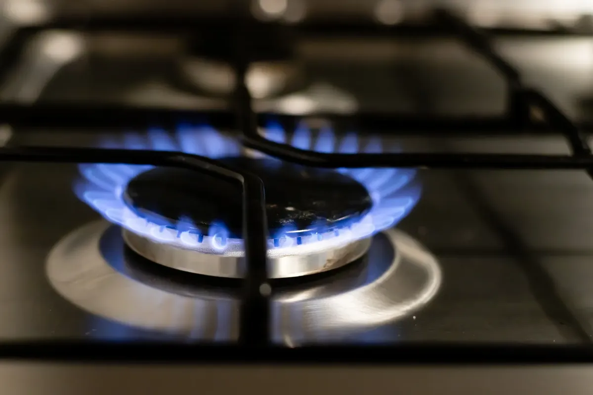 A detailed view of a blue flame on a stove, showcasing energy and heat.