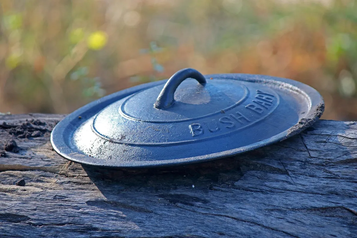 cast iron pot lid, lid, cast iron, pot, strong, heavy, durable, cooking, camping, metal, black, log, outdoors, blue cooking, blue camping, blue metal, lid, lid,